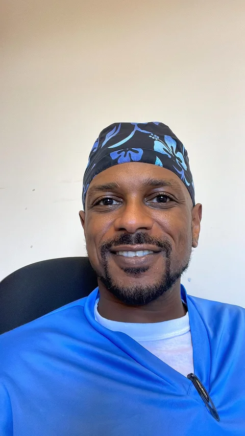 Dr. Mekki Medani in surgical scrubs at the operating theatre